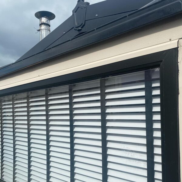 Mobile home fitted with white Venetians with black tapes to give it that extra detail